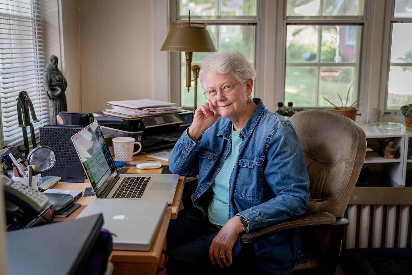 Photograph of a St. Louis author at her desk writing a book. 